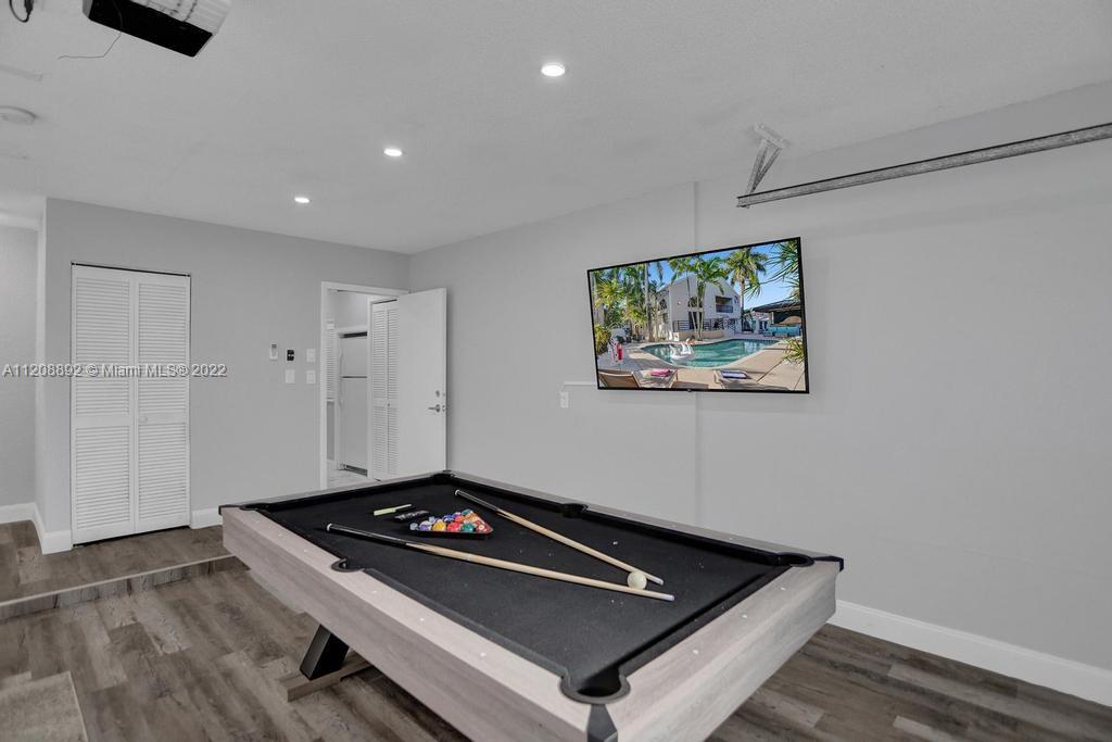 960 Northwest 4th Court Boca Raton, FL 33432 - Photo 44 of 75 a room with painting on the wall and a wooden floor