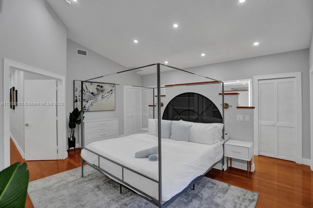960 Northwest 4th Court Boca Raton, FL 33432 - Photo 51 of 75 a bedroom with a bed and a dresser