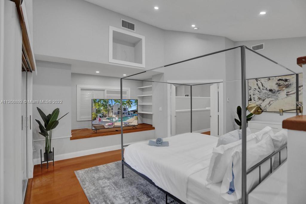 960 Northwest 4th Court Boca Raton, FL 33432 - Photo 52 of 75 a bedroom with a bed and a potted plant