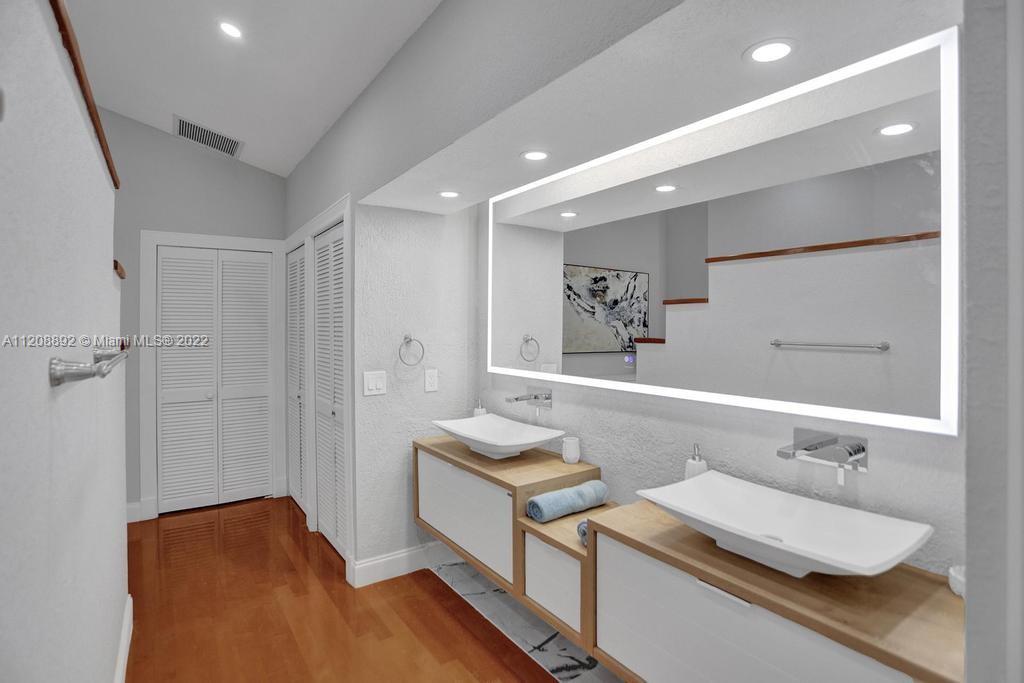 960 Northwest 4th Court Boca Raton, FL 33432 - Photo 53 of 75 a bathroom with a sink and a mirror