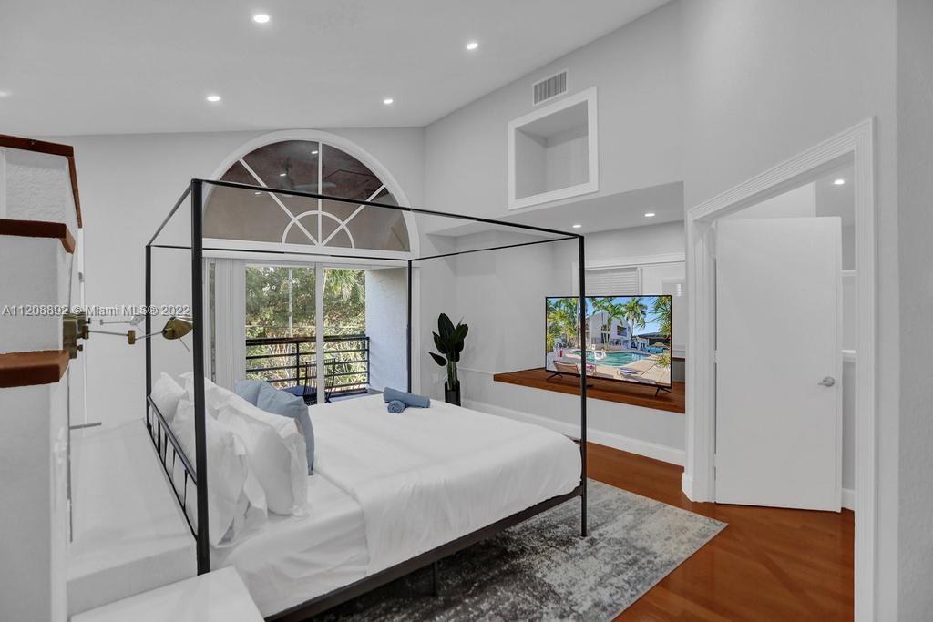 960 Northwest 4th Court Boca Raton, FL 33432 - Photo 56 of 75 a bed room with a bed and a mirror