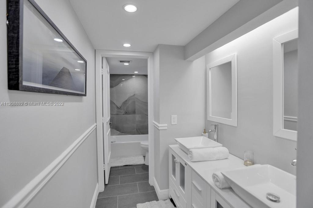 960 Northwest 4th Court Boca Raton, FL 33432 - Photo 62 of 75 a bathroom with a sink a toilet and shower