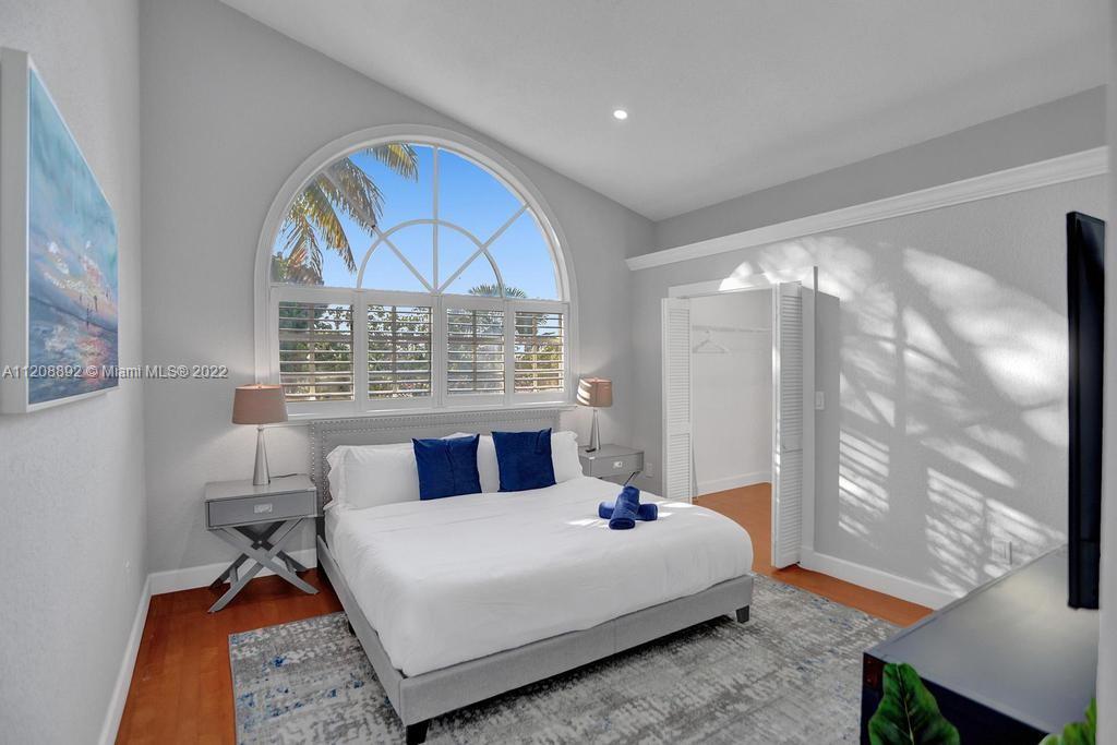 960 Northwest 4th Court Boca Raton, FL 33432 - Photo 66 of 75 a bedroom with a large bed and a window