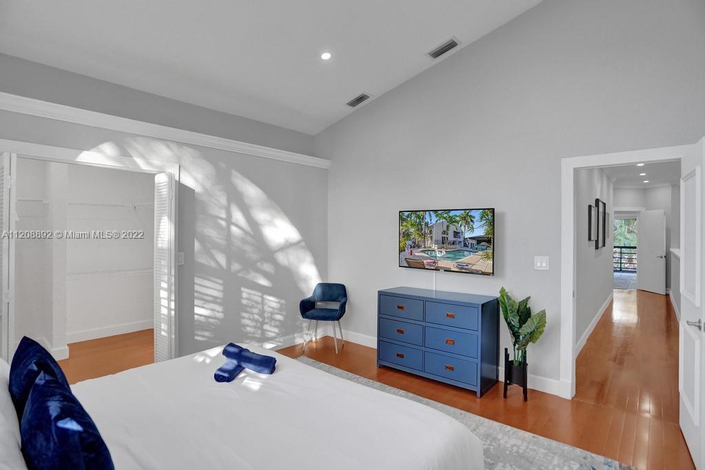 960 Northwest 4th Court Boca Raton, FL 33432 - Photo 67 of 75 a bedroom with a bed and wooden floor