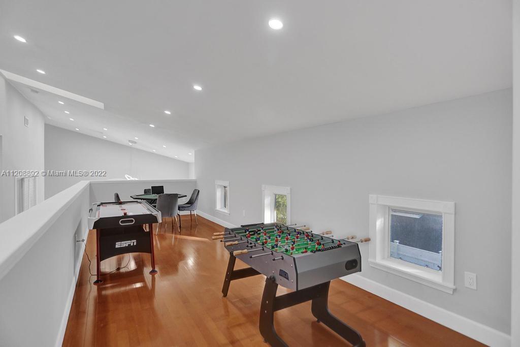 960 Northwest 4th Court Boca Raton, FL 33432 - Photo 72 of 75 a room with furniture and a wooden floor