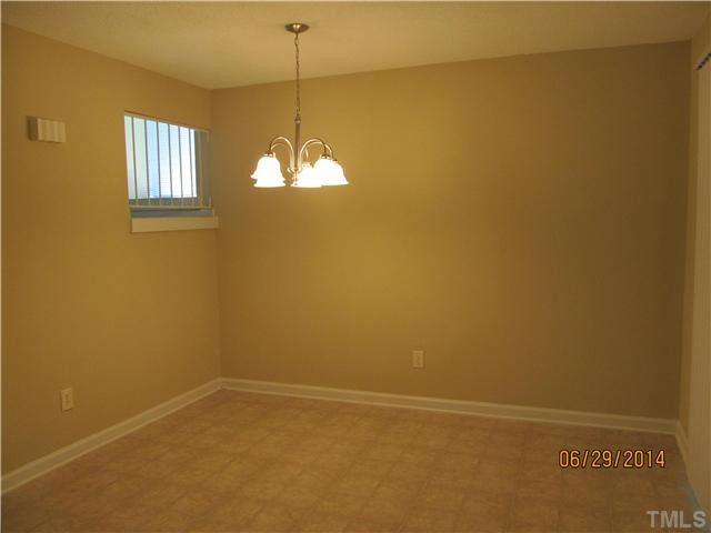 4253 Lake Ridge Drive Raleigh, NC 27604 - Photo 10 of 22 a view of an empty room with window and chandelier fan