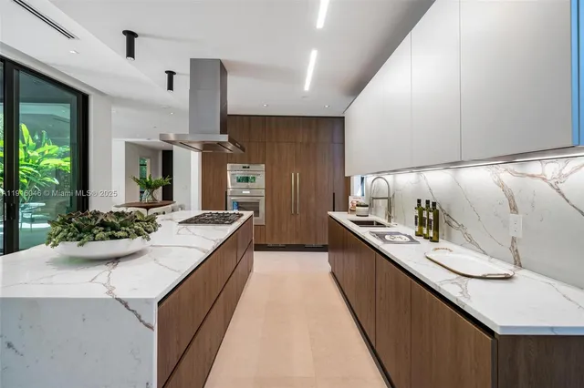 a view of kitchen with kitchen island a large window in it