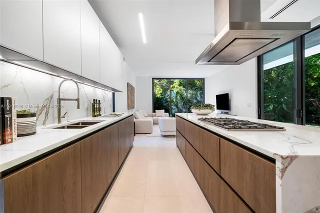 a dining room with furniture and kitchen view