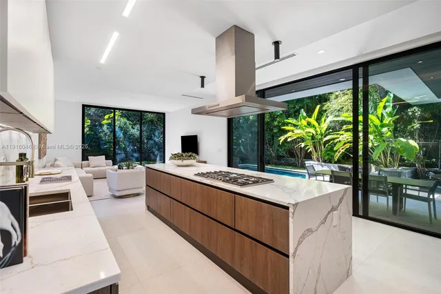 a kitchen with a table a stove and white cabinets
