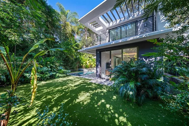 a spacious bedroom with a large bed and a chandelier