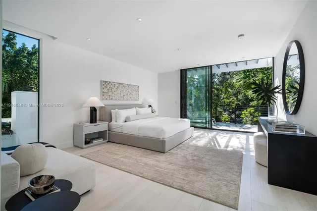 a large white bathroom with a granite countertop sink mirror and bathtub