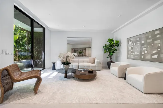 a living room with fireplace furniture and a large window