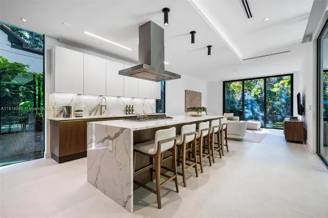 a large kitchen with stainless steel appliances granite countertop a stove and a sink