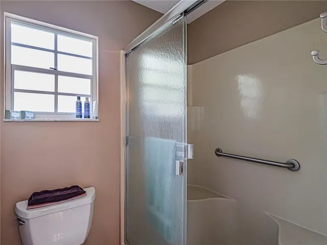 a bathroom with a toilet and a shower