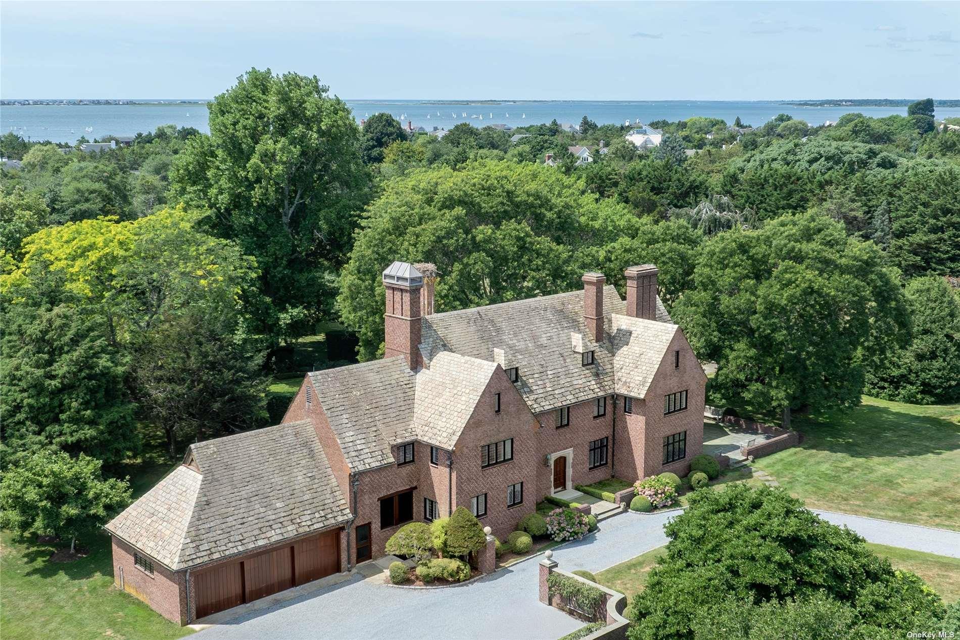 an aerial view of a house with yard and outdoor seating