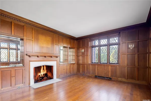 a view of an empty room with a fireplace and a window