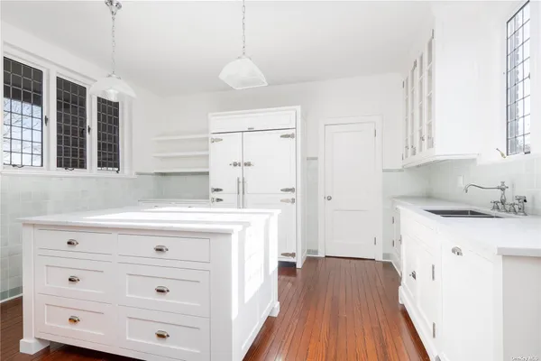 a kitchen with a stove a sink and a refrigerator