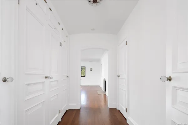 a view of a hallway with wooden floor