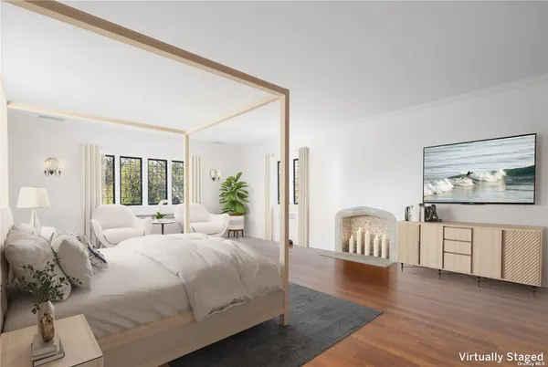 a bedroom with furniture and a wooden floor