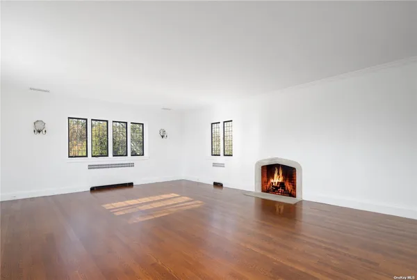 a view of a livingroom with a fireplace and wooden floor