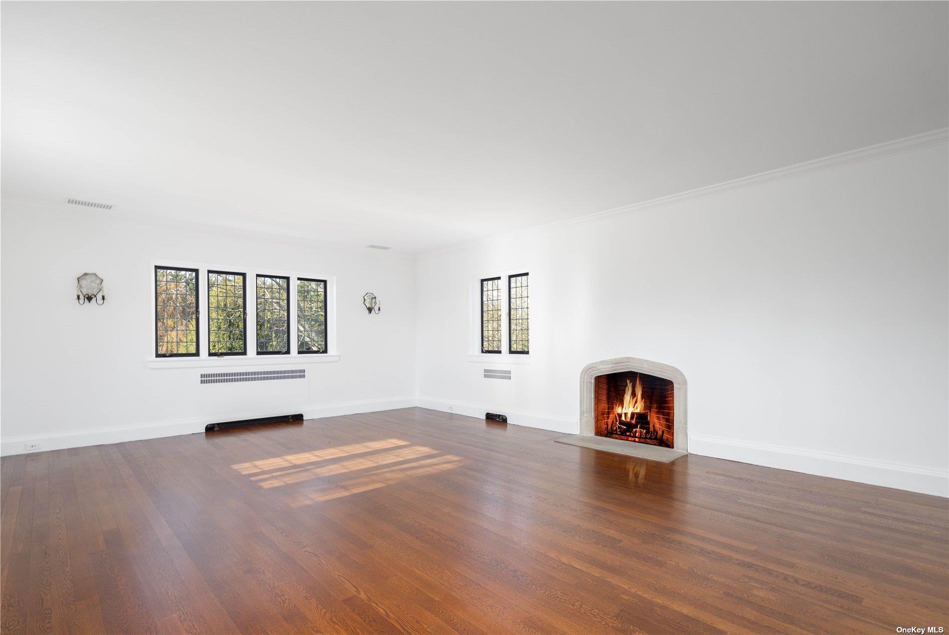 16 Tuthill Lane Remsenburg, NY 11960 - Photo 19 of 32 a view of a livingroom with a fireplace and wooden floor