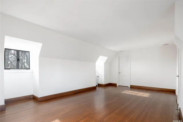 a view of a room with wooden floor and white walls