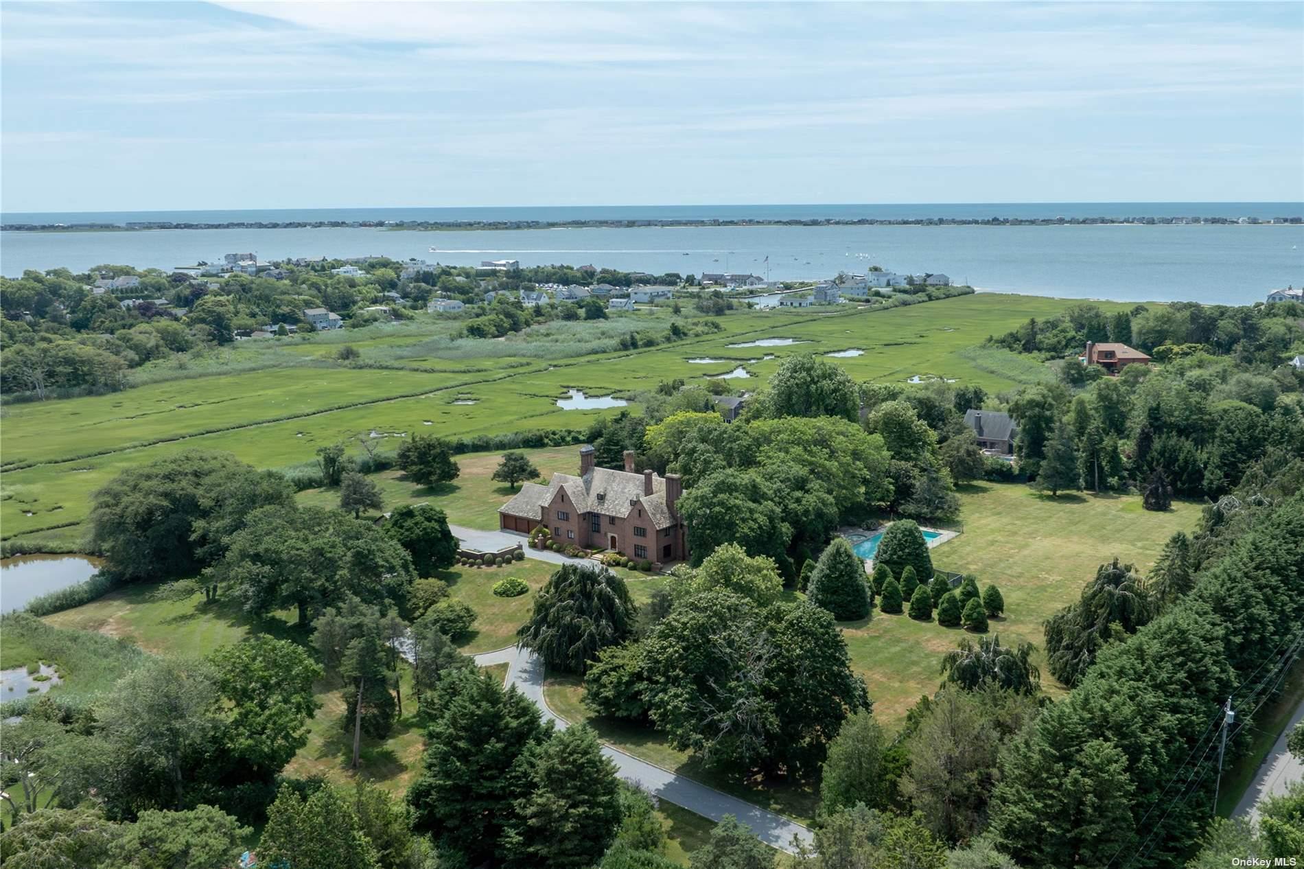 16 Tuthill Lane Remsenburg, NY 11960 - Photo 31 of 32 an aerial view of a houses with outdoor space and trees all around