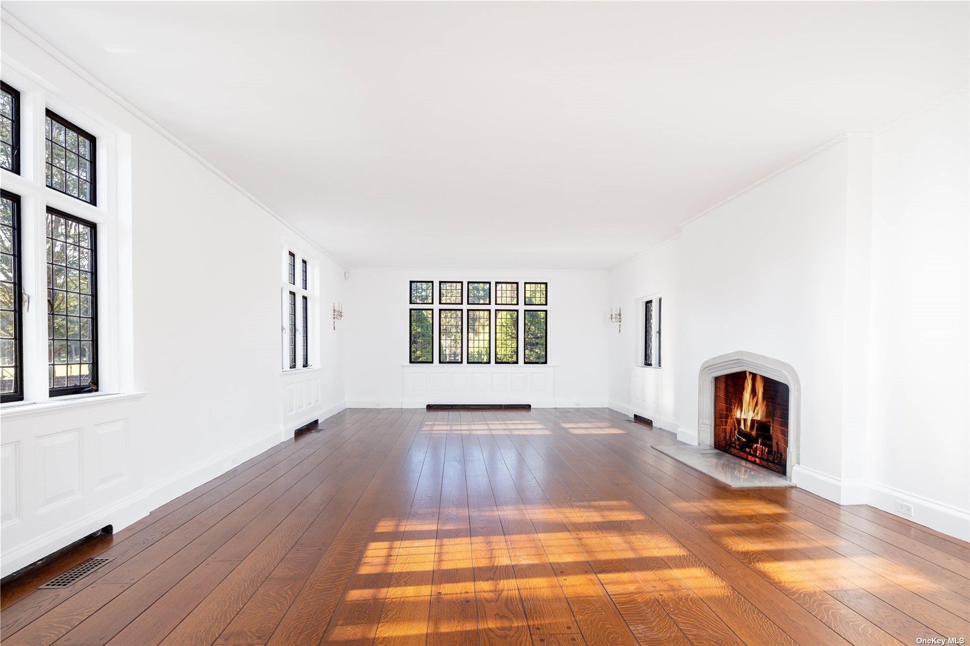 16 Tuthill Lane Remsenburg, NY 11960 - Photo 8 of 32 a view of an empty room with window and wooden floor