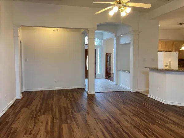 wooden floor fireplace and windows in an empty room