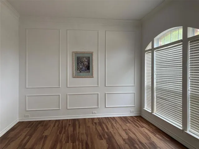 a view of a room with wooden floor and white walls