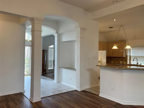 a kitchen with a sink a refrigerator and cabinets