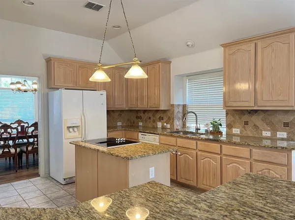 a view of a kitchen with a sink and cabinets