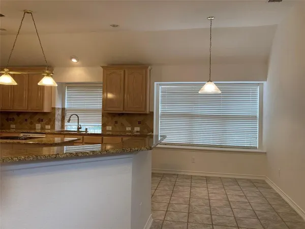 a kitchen with stainless steel appliances granite countertop a sink a stove and a refrigerator