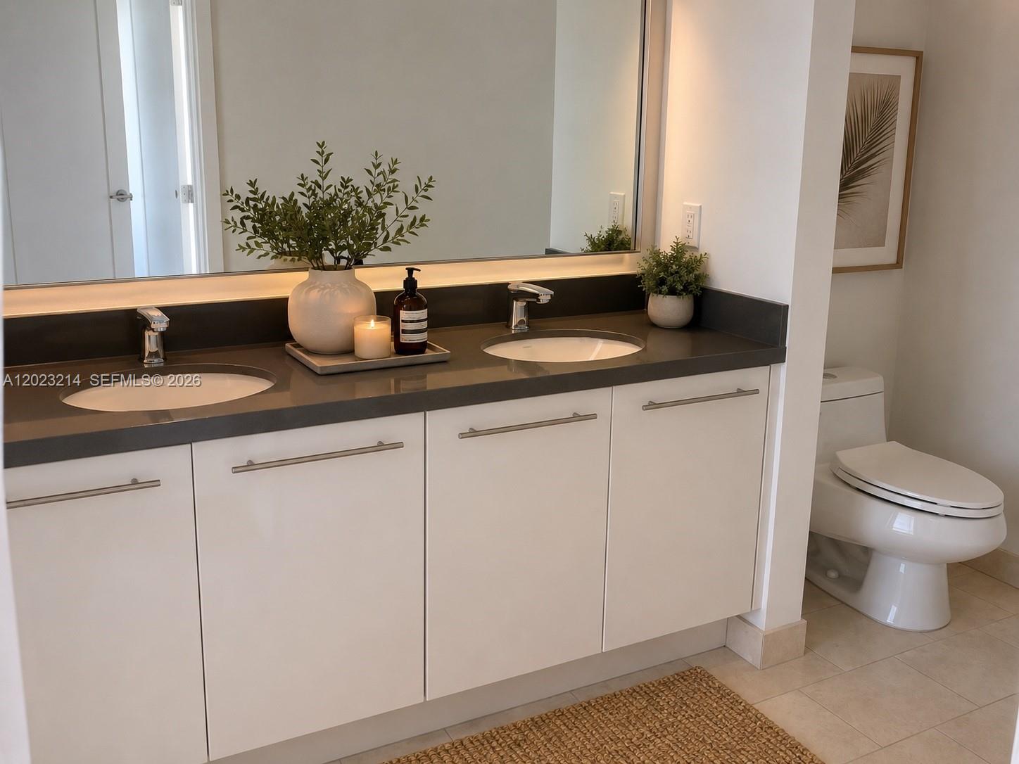 90 Southwest 3rd Street, Unit 2614 Miami, FL 33130 - Photo 8 of 13 a bathroom with a granite countertop sink and a toilet