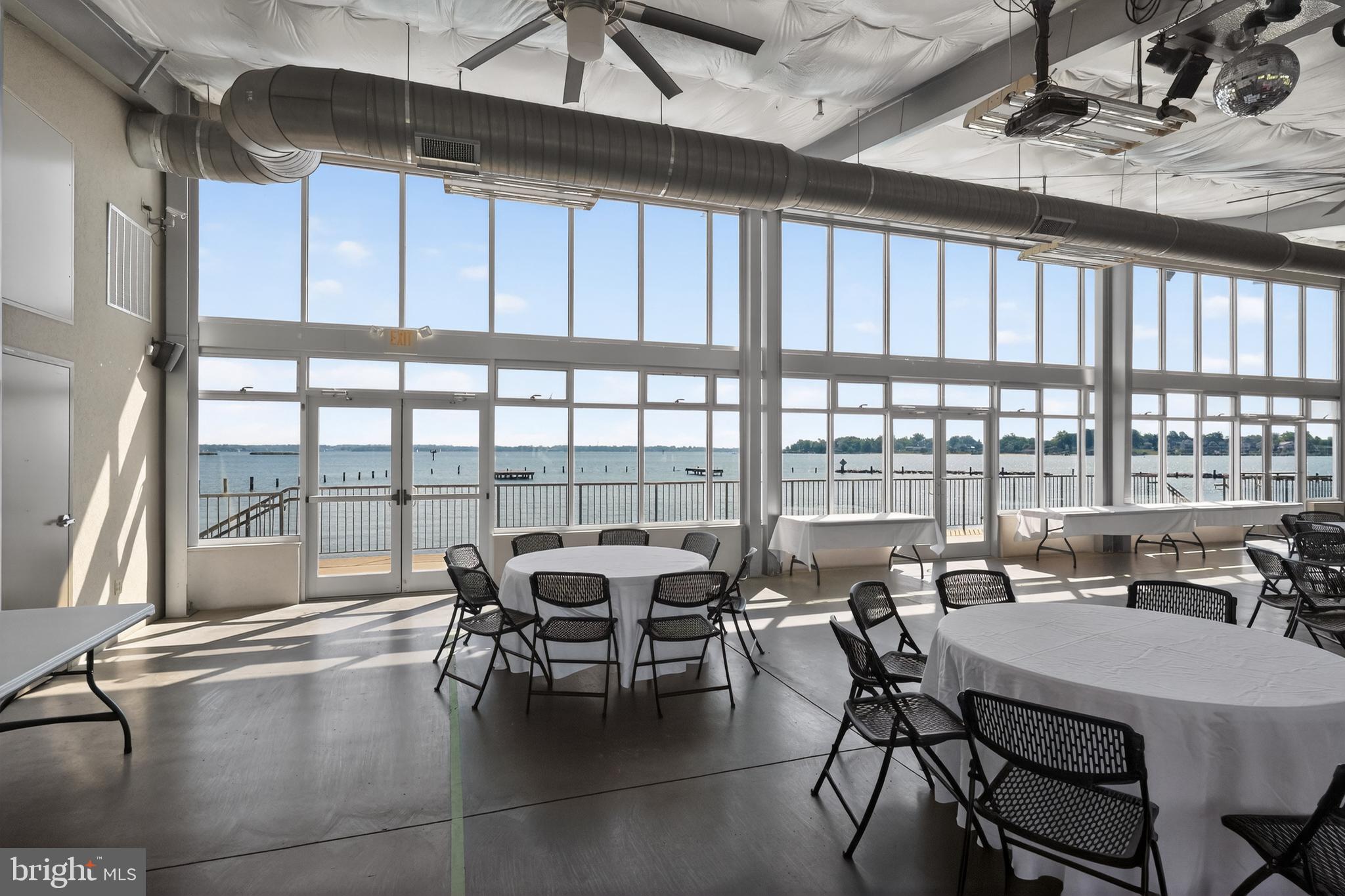 3670 5th Avenue Edgewater, MD 21037 - Photo 44 of 60 a dining room with furniture and floor to ceiling windows