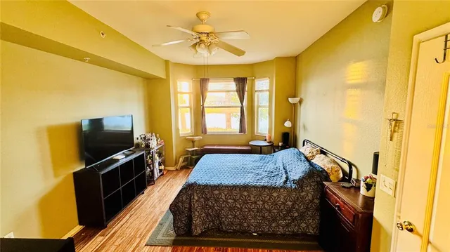 a bedroom with a bed and a television