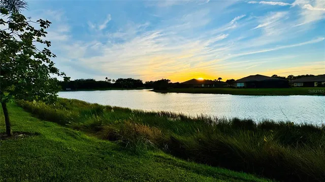 a view of a lake with houses in the back