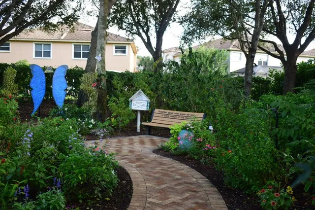 a front view of a house with a yard and potted plants