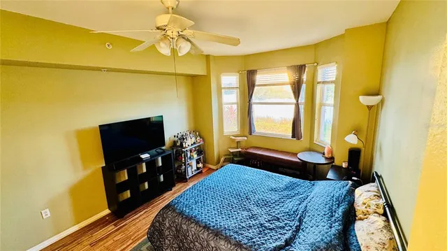 a bedroom with a bed and flat screen tv