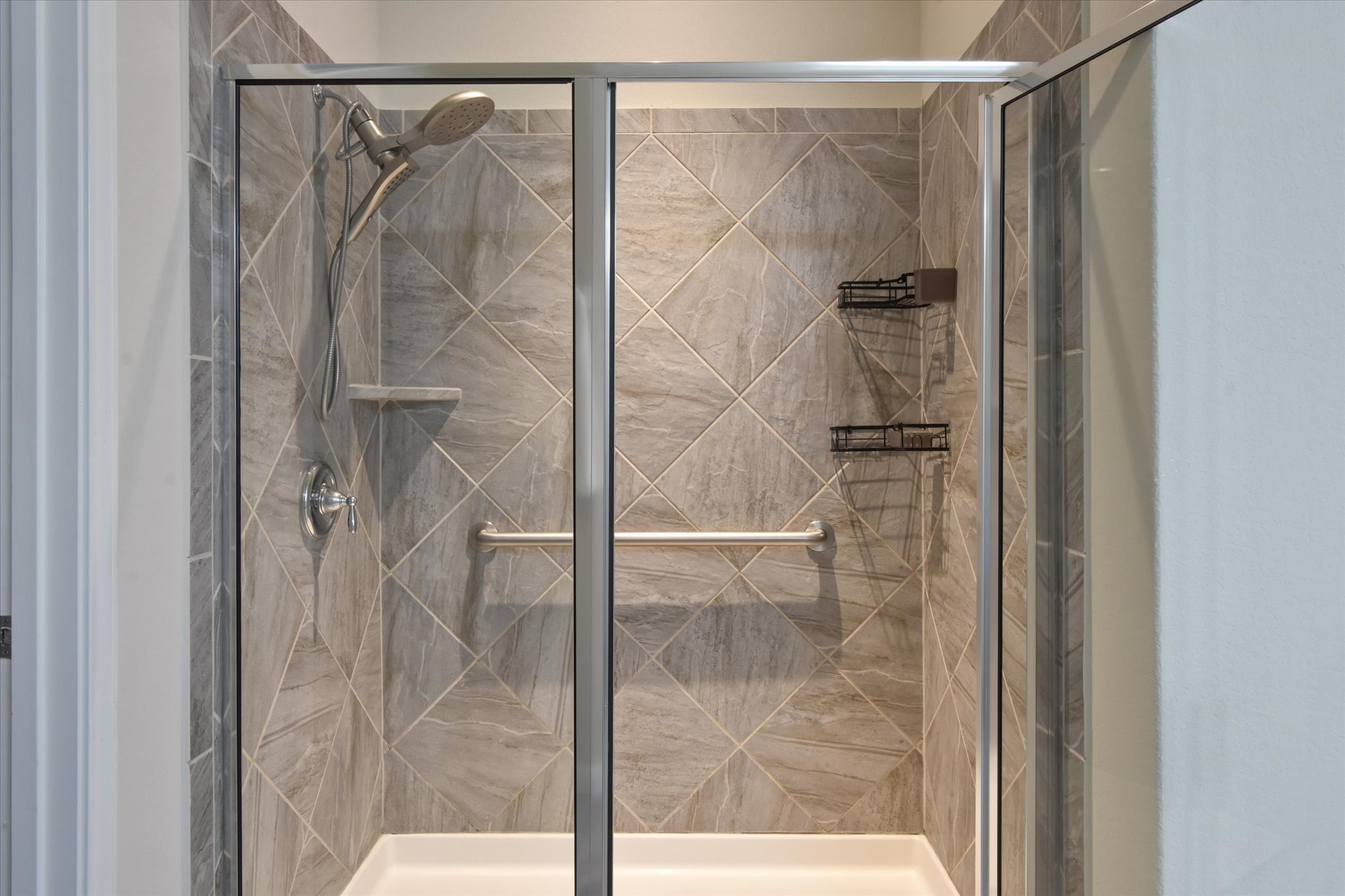 104 Coffee Mill Creek Road Georgetown, TX 78633 - Photo 25 of 40 A beautifully tiled shower with modern fixtures offers a refreshing retreat.