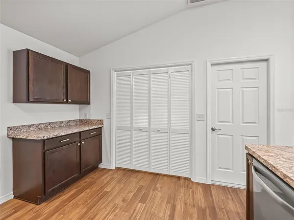 a kitchen with a sink and wooden floor