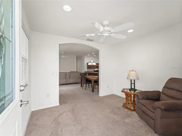 a living room with furniture and a chandelier