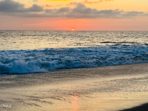 an empty room with wooden floor and a window
