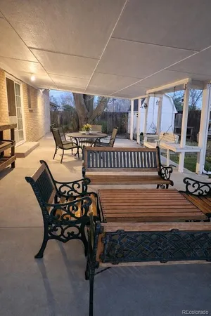 a dining room with furniture and a flat screen tv