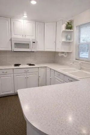 a dining room with furniture and chandelier