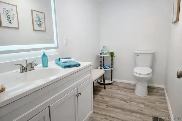 a living room with couch and wooden floor