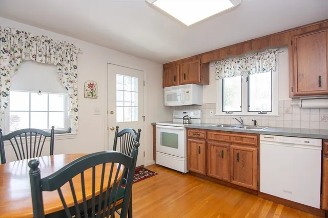 a kitchen with stainless steel appliances granite countertop a stove a sink dishwasher and microwave