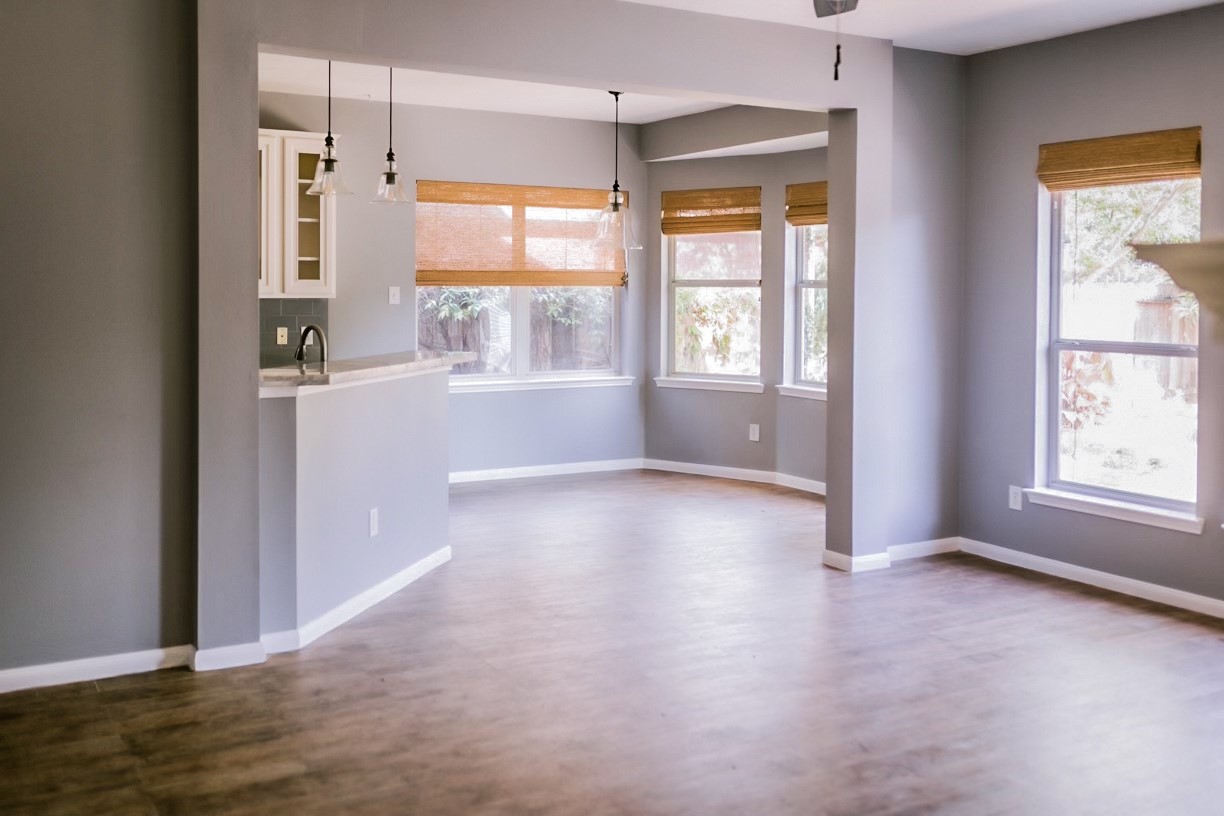 22402 Rue Canyon Court Katy, TX 77450 - Photo 18 of 18 This perspective showcases the true heart of the home, emphasizing an open floor plan. The effortless flow from the kitchen bar into the casual dining and living areas ensures the home chef is always part of the conversation. Crisp gray walls and matching crisp white baseboards frame the space beautifully, presenting a clean, modern canvas that is ready for your personal touch.