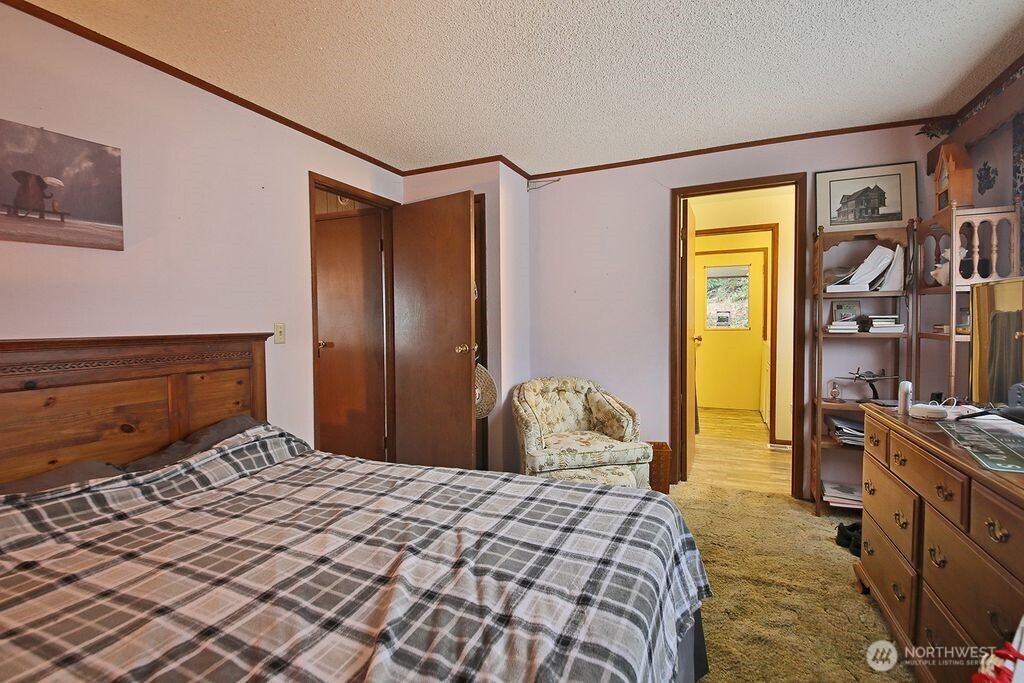 6423 South Admiralty Way Freeland, WA 98249 - Photo 8 of 11 a bedroom with a bed and cabinets