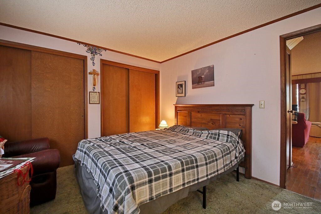 6423 South Admiralty Way Freeland, WA 98249 - Photo 9 of 11 a bedroom with a bed and a closet